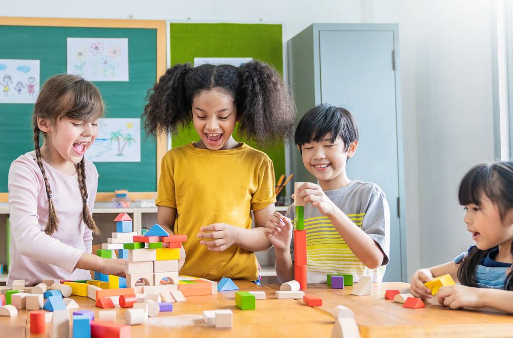 diverse group of kids playing with colorful blocks in classroom